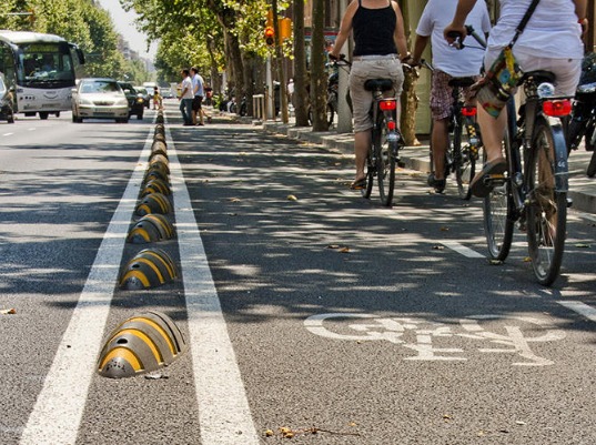 Curb stops, or more specifically products like the Armadillo, can help define a bike lane providing protection and slowing traffic down through visual cues.