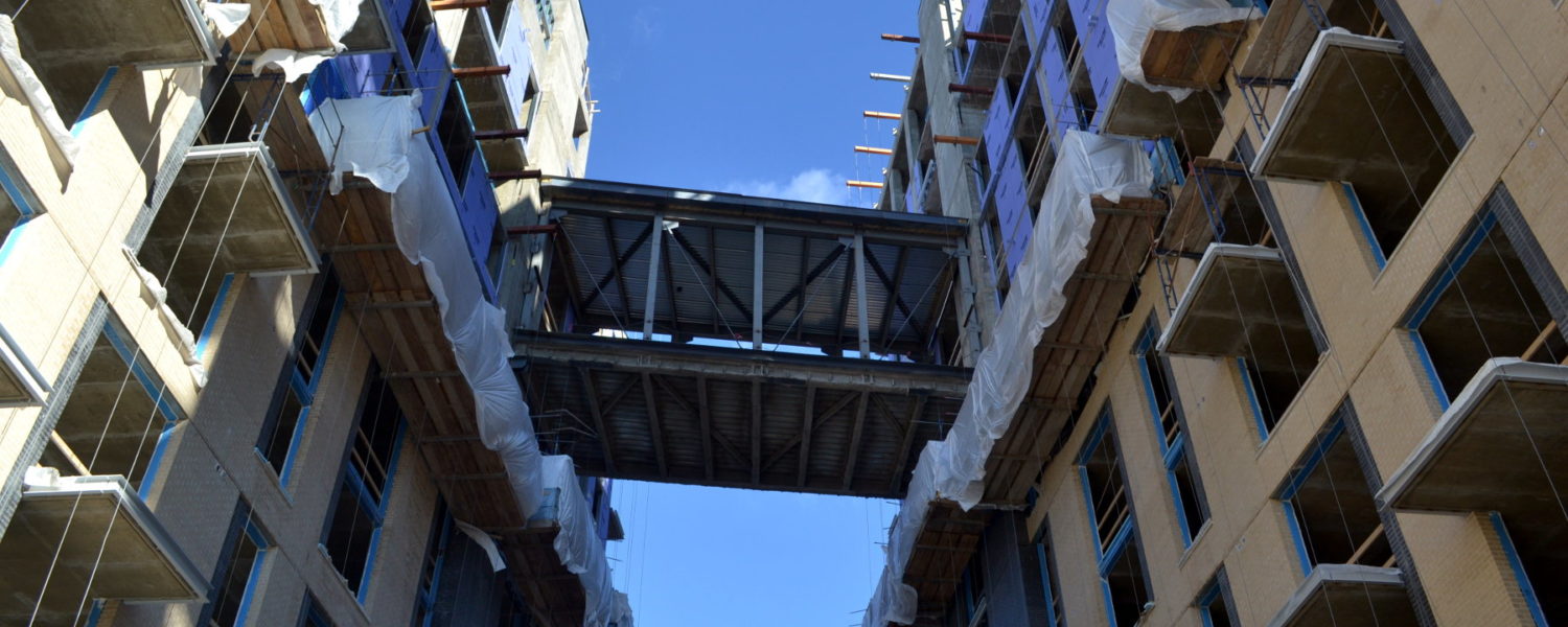 The sky bridge under construction at Kingston apartments